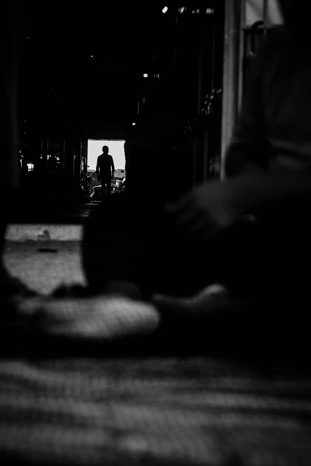 Person lying on the floor — photograph by Ibrahim Ifaaz