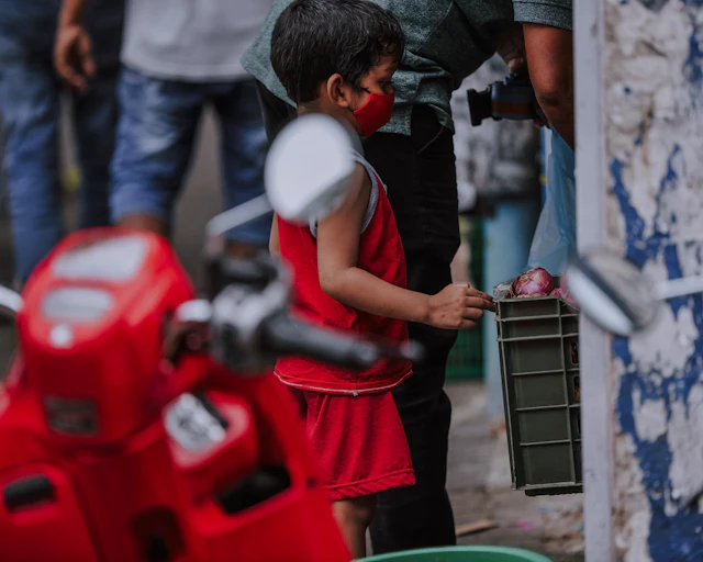Red shirt, metal frame — photograph by Ibrahim Ifaaz